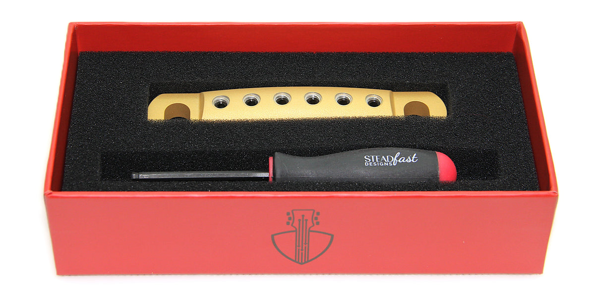 Gold Cerakote aluminum guitar stopbar in box with hex tool.