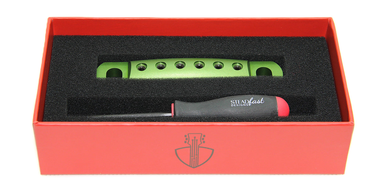 Green stopbar with black screws in box with branded hex tool.