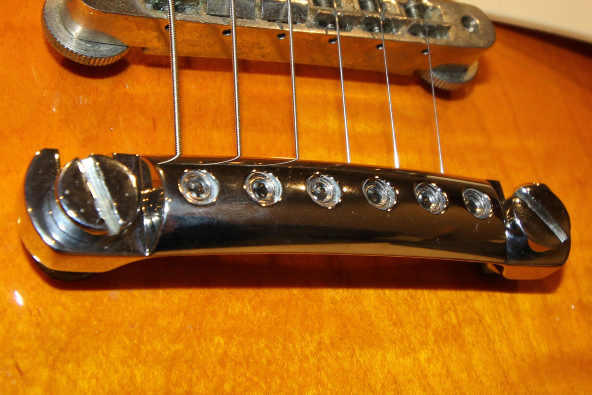 Close up of a lightweight CNC nickel plated stopbar installed on electric guitar