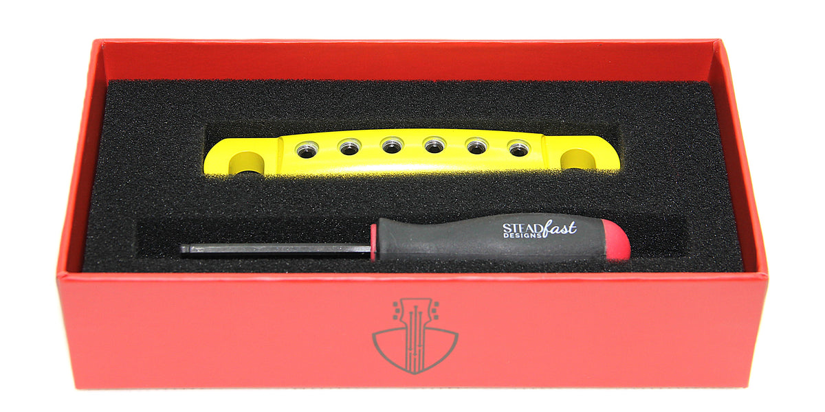 Yellow Cerakote aluminum guitar stopbar in box with hex tool.